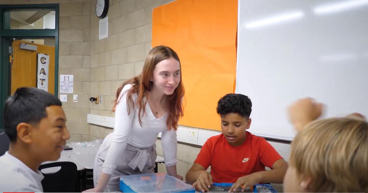   Teacher with students in a classroom